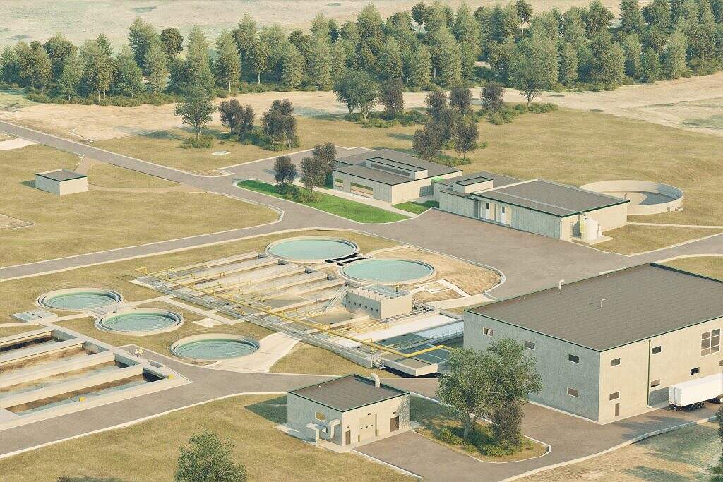 Aerial view of a modern water treatment facility, part of ALASD Projects, with multiple circular and rectangular tanks, buildings, and infrastructure, all surrounded by grassy areas and bordered by rows of trees.